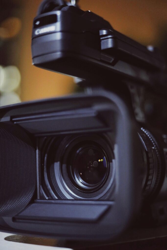Detailed close-up of a professional video camera lens capturing focus and precision.